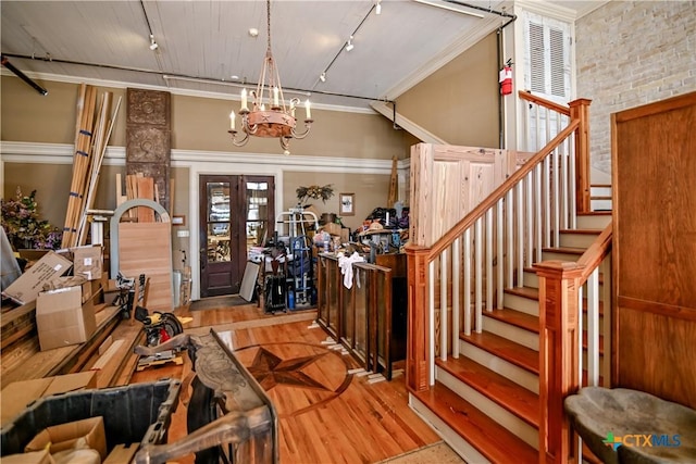 122 E Main St, Cuero, TX 77954 - entryway with wood finished floors, track lighting, a chandelier, stairway, and crown molding