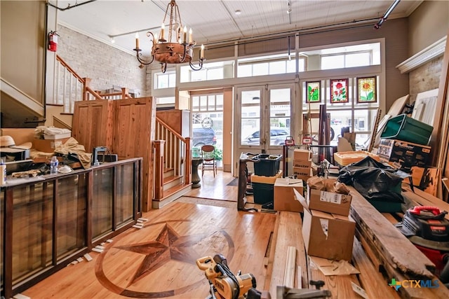 122 E Main St, Cuero, TX 77954 - misc room with a high ceiling, stairs, light wood-type flooring, track lighting, and french doors