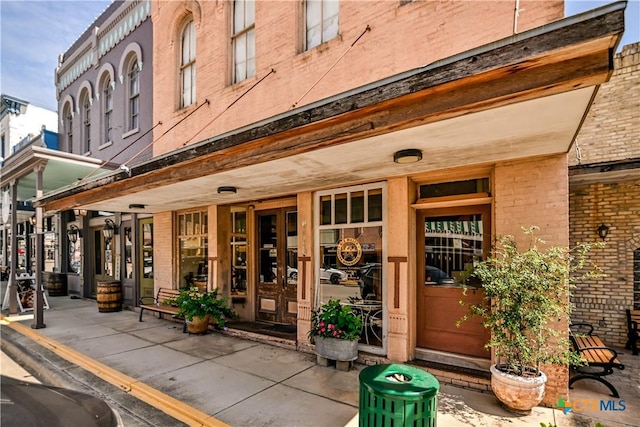122 E Main St, Cuero, TX 77954 - property entrance featuring french doors and brick siding