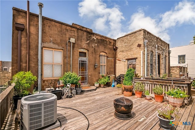 122 E Main St, Cuero, TX 77954 - wooden deck with a fire pit and central AC unit
