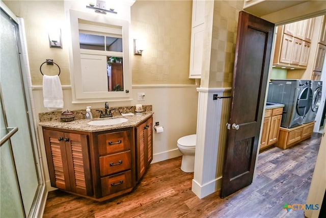 122 E Main St, Cuero, TX 77954 - full bathroom with washer and dryer, wood finished floors, and toilet
