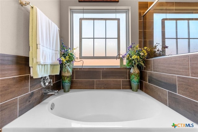 bathroom with a tub to relax in