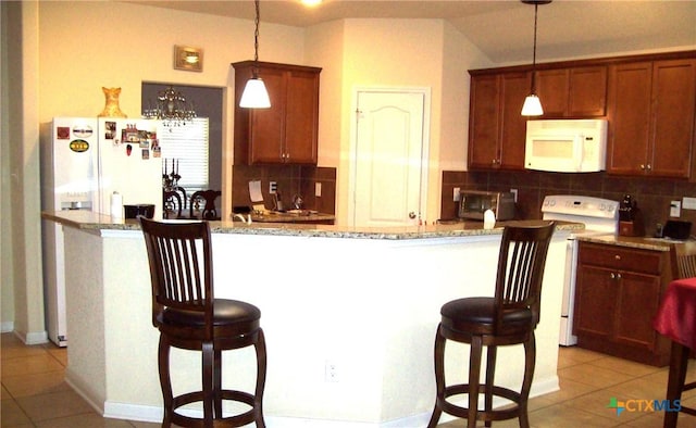 kitchen featuring white appliances, decorative light fixtures, decorative backsplash, and light tile patterned floors