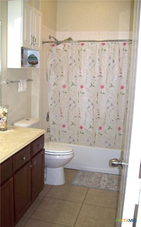 full bathroom with tile patterned flooring, vanity, shower / tub combo, and toilet