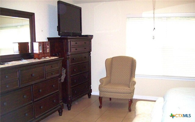 sitting room with plenty of natural light and light tile patterned floors