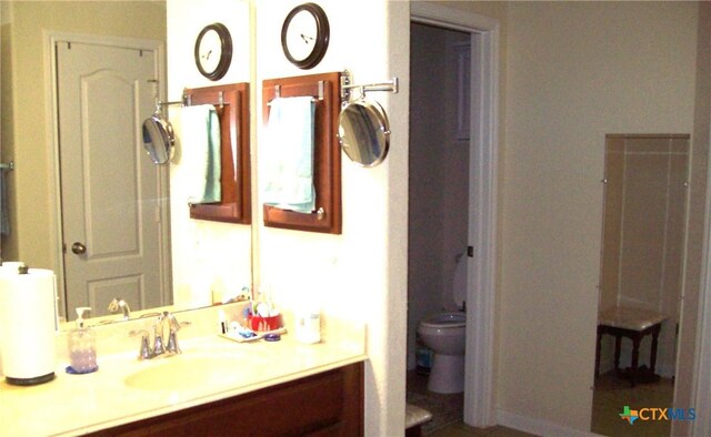 bathroom featuring vanity and toilet