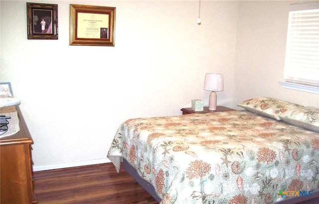 bedroom with dark wood-type flooring