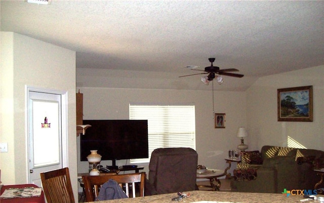 living room featuring lofted ceiling and ceiling fan