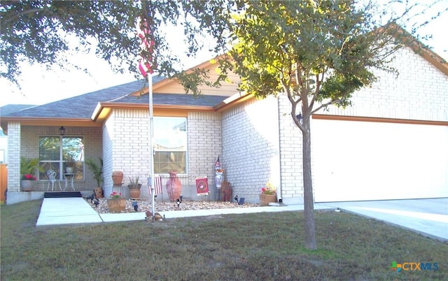 rear view of property featuring a yard and a garage