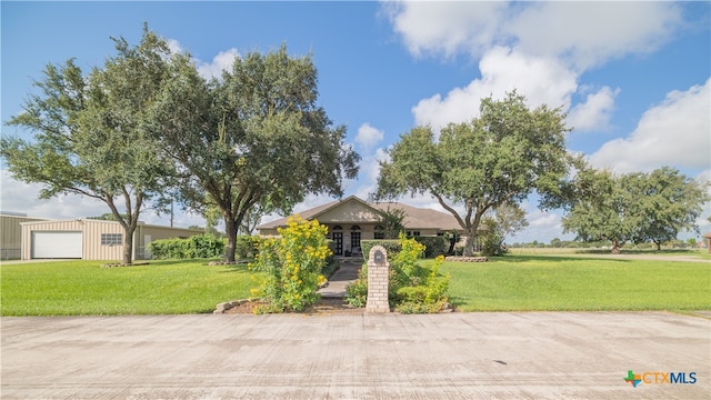 ranch-style house featuring a garage and a front yard