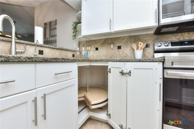 3404 American Dr Unit 3315, Lago Vista, TX 78645 - kitchen featuring stone countertops, appliances with stainless steel finishes, decorative backsplash, and white cabinetry