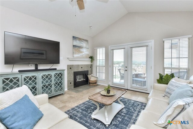 3404 American Dr Unit 3315, Lago Vista, TX 78645 - tiled living room featuring french doors, ceiling fan, a fireplace, and lofted ceiling