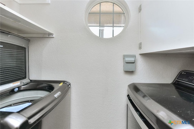 3404 American Dr Unit 3315, Lago Vista, TX 78645 - laundry area featuring cabinet space, washer / dryer, and a textured wall