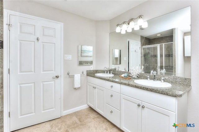 3404 American Dr Unit 3315, Lago Vista, TX 78645 - bathroom featuring double vanity, baseboards, a sink, and a stall shower