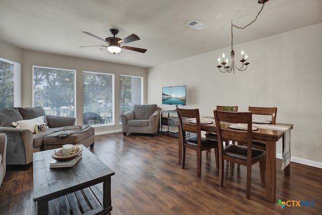 dining room featuring dark hardwood / wood-style flooring and ceiling fan with notable chandelier