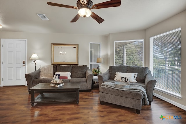 living room with dark wood-type flooring and ceiling fan