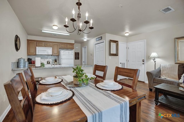 730 E Mather St Unit B101, New Braunfels, TX 78130 - dining area featuring dark wood finished floors and a chandelier