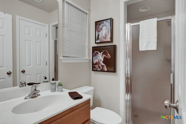 bathroom with vanity, toilet, and an enclosed shower