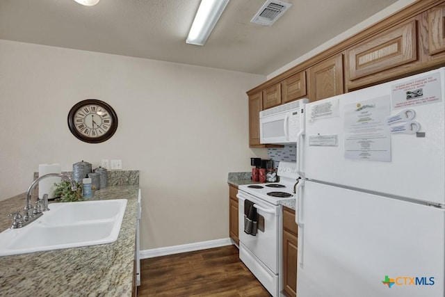 730 E Mather St Unit B101, New Braunfels, TX 78130 - kitchen featuring white appliances, dark wood-type flooring, light countertops, and brown cabinets