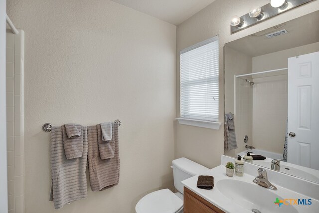 full bathroom featuring vanity,  shower combination, and toilet