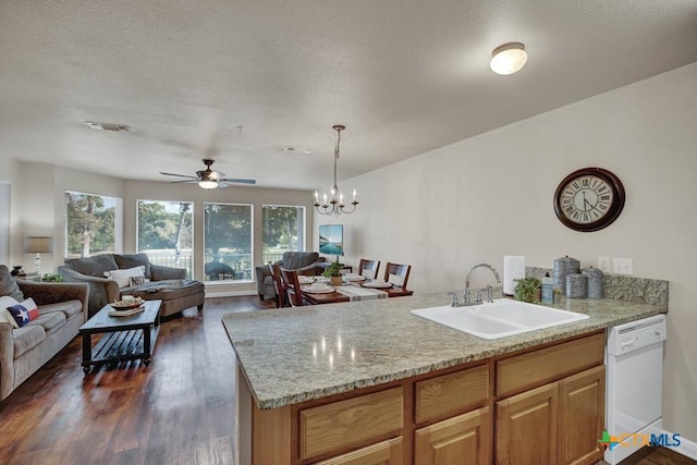 730 E Mather St Unit B101, New Braunfels, TX 78130 - kitchen featuring white dishwasher, a peninsula, open floor plan, dark wood-style flooring, and a textured ceiling