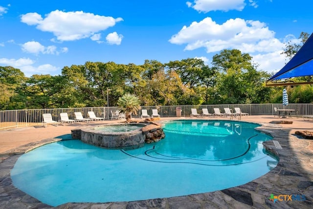 730 E Mather St Unit B101, New Braunfels, TX 78130 - view of pool with a patio, a pool with connected hot tub, and view of scattered trees
