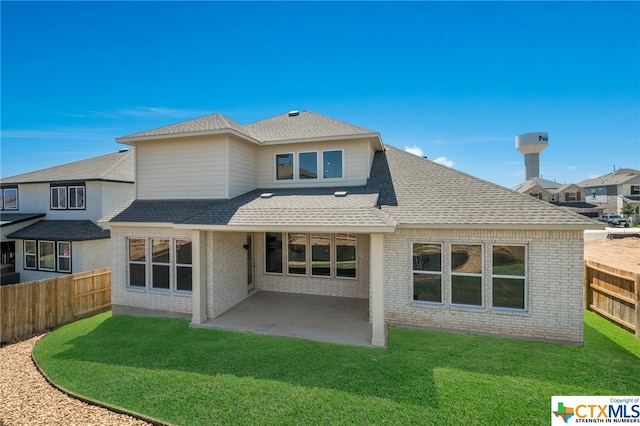 back of house featuring a yard and a patio area