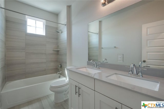 2240 Sur Ave, New Braunfels, TX 78132 - bathroom featuring toilet, double vanity, and shower / washtub combination