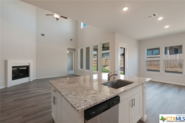 kitchen with dishwasher, white cabinetry, a wealth of natural light, and sink