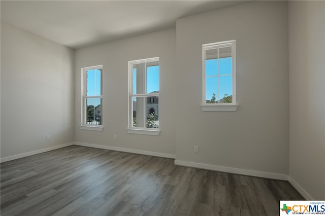 spare room with dark hardwood / wood-style floors