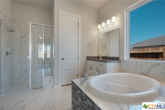 bathroom with vanity and separate shower and tub