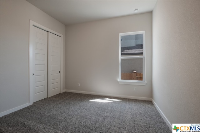 unfurnished bedroom featuring a closet and carpet