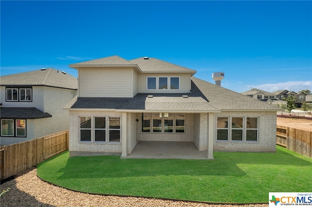 rear view of house featuring a patio area and a lawn