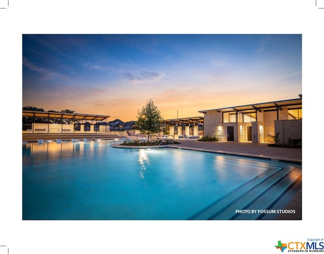 view of pool at dusk