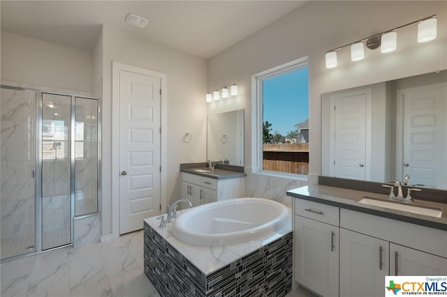 2240 Sur Ave, New Braunfels, TX 78132 - bathroom with a bath, two vanities, a marble finish shower, and marble look tiles