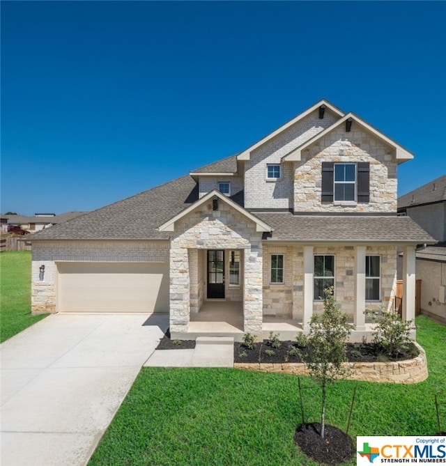 view of front of property with a garage and a front yard