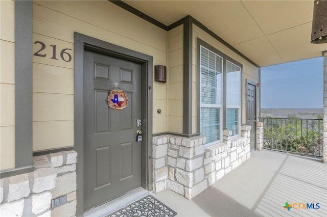 view of exterior entry featuring stone siding