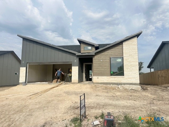 2217 Wooster St, Nolanville, TX 76559 - view of front facade featuring a garage, dirt driveway, and fence