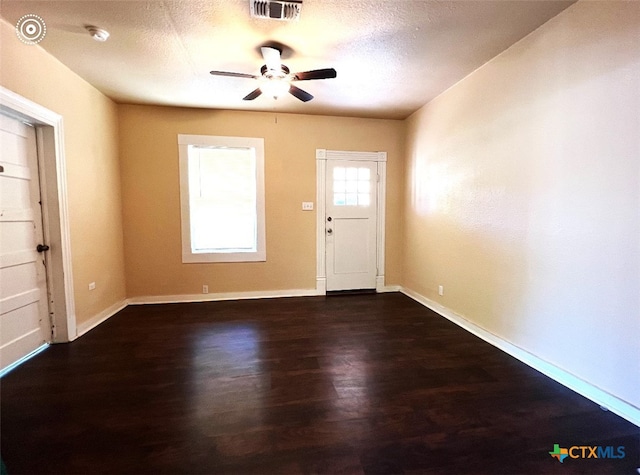 foyer featuring ceiling fan, a textured ceiling, and dark hardwood / wood-style flooring