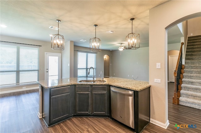 kitchen with dishwasher, dark wood-type flooring, sink, and light stone counters