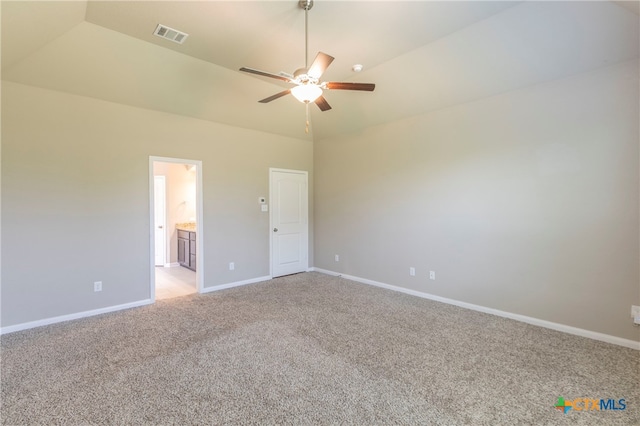 unfurnished bedroom with lofted ceiling, light carpet, ceiling fan, and ensuite bathroom