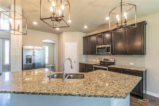 kitchen featuring a healthy amount of sunlight, appliances with stainless steel finishes, sink, and decorative light fixtures