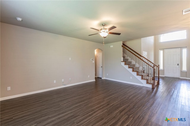 unfurnished living room featuring ceiling fan and dark hardwood / wood-style floors