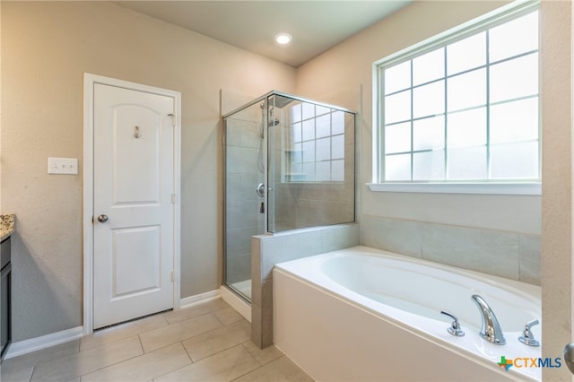 bathroom with vanity, tile patterned floors, and plus walk in shower