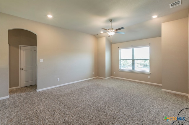 carpeted spare room with ceiling fan