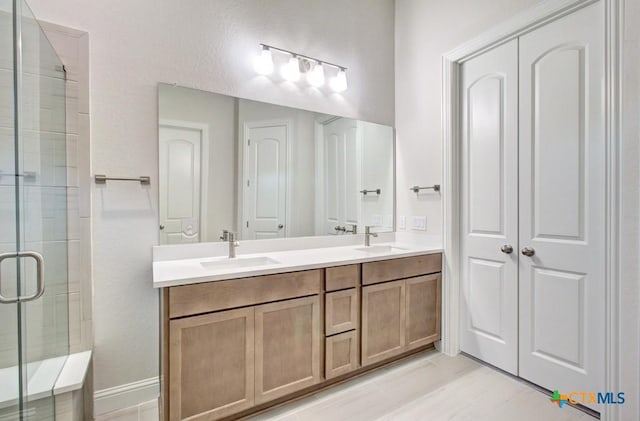 737 Groudsel Ave, New Braunfels, TX 78132 - bathroom featuring double vanity, a sink, and a stall shower