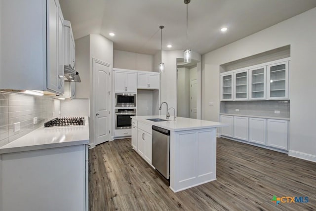 737 Groudsel Ave, New Braunfels, TX 78132 - kitchen with white cabinetry, light countertops, dark wood-style flooring, stainless steel appliances, and a sink
