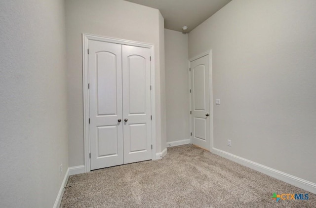 737 Groudsel Ave, New Braunfels, TX 78132 - unfurnished bedroom featuring light carpet, baseboards, and a closet