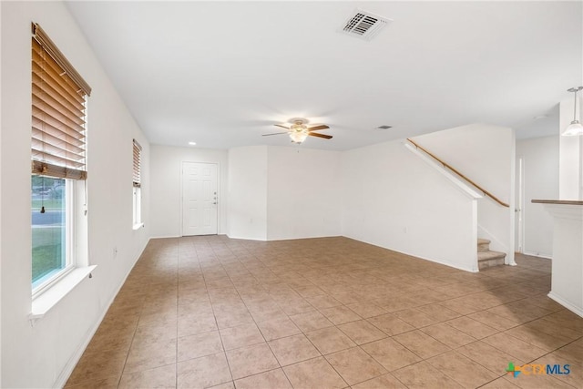 8913 Winter Haven Rd, Austin, TX 78747 - unfurnished living room featuring a ceiling fan, light tile patterned floors, and stairs