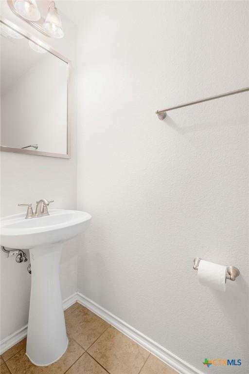 8913 Winter Haven Rd, Austin, TX 78747 - bathroom featuring tile patterned floors, baseboards, and a sink